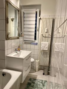 a white bathroom with a sink and a toilet at Appartment Anna-Louise in Sondershausen