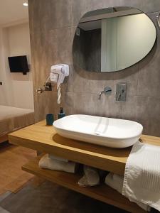 a bathroom with a sink and a mirror at 9 Muses Apartments in Agios Nikolaos