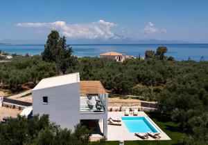 an external view of a villa with a swimming pool at Ariadne Elegant Villa in Psarou