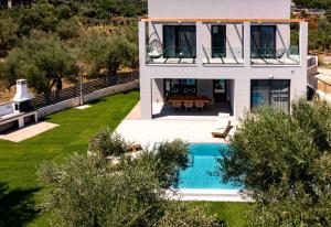 an aerial view of a house with a swimming pool at Ariadne Elegant Villa in Psarou