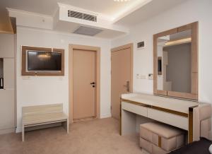 a bathroom with a sink and a mirror at Pelit Park Hotel in Trabzon