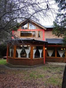 a house with white vases in the windows of it at Maitenkarú in San Carlos de Bariloche