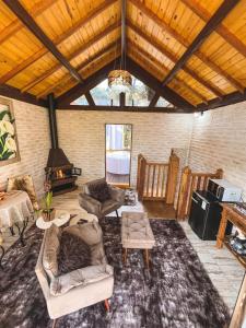 a living room with couches and a fireplace at Estalagem Monte Verde in Monte Verde