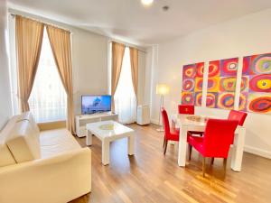 a living room with a couch and a table at Steiner Residences Vienna Augarten in Vienna