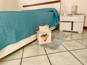 a bedroom with a bed with a box on the floor at AMATI HOLIDAYS in Palermo