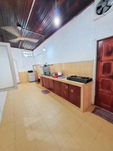 a large room with a kitchen with a counter at Homestay Kuala Terengganu One Stop 1 in Kuala Terengganu