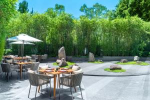 a patio with tables and chairs in a garden at Hyatt Regency Mexico City in Mexico City