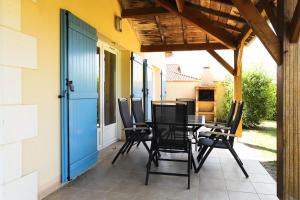 a patio with a table and chairs on it at French country home III in Les Forges