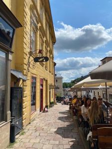 a group of people sitting at tables outside a building at Apartmán v Žltom dome in Banská Štiavnica