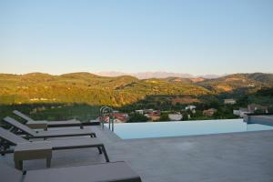 a swimming pool with a view of the mountains at Villa Olive Valley in Loutrákion