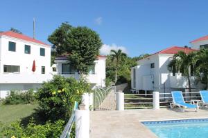 a view of a house and a swimming pool at Serene Cruz Bay Villa Sep Mstr Kg Suite Stunning Sunsets in Cruz Bay