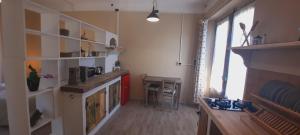 a room with a kitchen with a fireplace and a table at La Corte dei Cerri, Il Tornio in Spervara