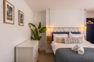 a bedroom with a bed with a blue headboard at The Servant’s Quarters in Whitby