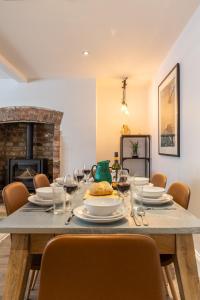 a dining room with a table with chairs and a fireplace at The Servant’s Quarters in Whitby