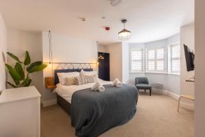 a bedroom with a large bed and a chair at The Servant’s Quarters in Whitby +15 photos