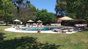a swimming pool with lounge chairs and a fire hydrant at Dalyan Riverside Private Gaia Koru Bungalows with Swimming Pool Adults Only in Ortaca