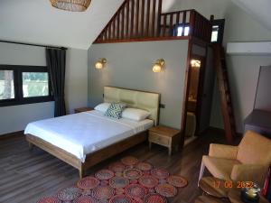 a bedroom with a bed and a stair case at Gaia Koru Bungalows in Ortaca