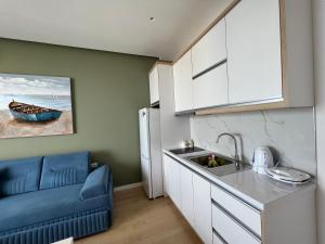 a small kitchen with a sink and a refrigerator at Dani's Apartments in Sarandë