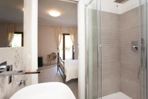 a bathroom with a shower with a glass door at B&B Lu Lioni in San Teodoro