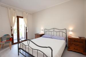 Postel nebo postele na pokoji v ubytování Lu Lioni Rooms