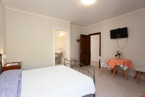 Postel nebo postele na pokoji v ubytování Lu Lioni Rooms