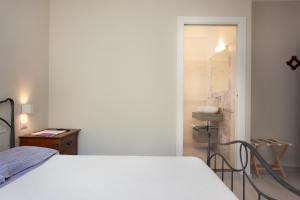 Postel nebo postele na pokoji v ubytování Lu Lioni Rooms