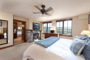 a bedroom with a bed with a ceiling fan and a fireplace at Purgatory Lodge Unit 501 in Durango Mountain Resort +38 photos
