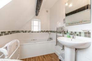 a bathroom with a sink and a bath tub and a sink at Brincliffe Cottage in Robin Hood's Bay +30 photos