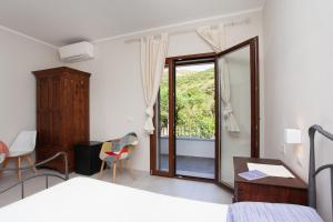 Postel nebo postele na pokoji v ubytování Lu Lioni Rooms
