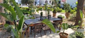 a table and chairs in a garden with plants at Azalea Garden Apartment With Mountain View in Kremasti