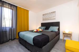 a bedroom with a large bed and a window at Providenca Accommodation in Mali Lošinj