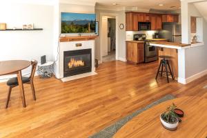 a kitchen and living room with a fireplace at Deschutes Nest in Bend +22 photos