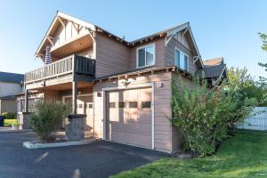 a large house with a garage in front of it at Deschutes Nest in Bend