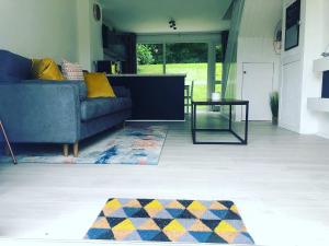 a living room with a couch and a table at Newquay Holiday Home in Newquay