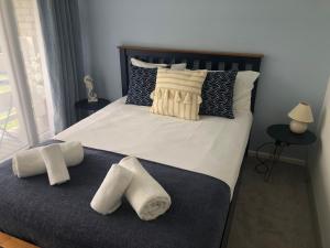 a bedroom with a large bed with towels on it at Newquay Holiday Home in Newquay