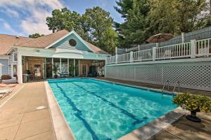 a swimming pool in front of a house at Cozy Norwich Villa on Golf Course Near Spa! in Norwich