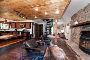 a large living room with a stone fireplace at 27 Columbine Drive Lake of the Pines in Durango