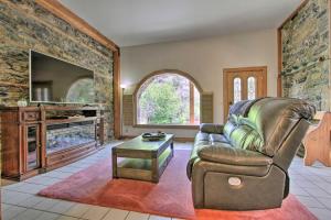 a living room with a couch and a tv at Historic Helena Retreat - Near Dtwn and Mt Helena! in Helena