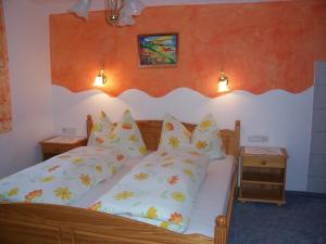 a bedroom with a wooden bed with pillows at Haus Emberger in Gerlos +12 photos