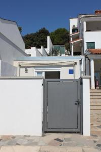 a door in the side of a white building at Apartments Estelle in Pula