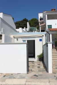 a white building with a door in front of it at Apartments Estelle in Pula