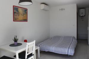 a bedroom with a bed and a table and a table and chair at Apartments Estelle in Pula