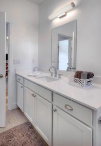 a white bathroom with a sink and a mirror at 436 Estancia Loop in Hermosa