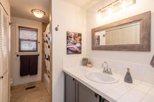 a bathroom with a sink and a mirror at BEkiND Cottage in Bend +46 photos
