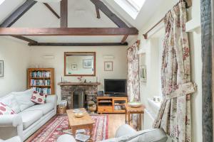 a living room with a couch and a fireplace at Sleepy Hollow in Ironbridge