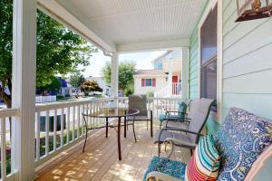 a screened in porch with a table and chairs at Town of Rehoboth Beach 109 Country Club Dr in Rehoboth Beach