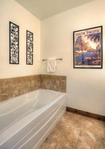 a bathroom with a tub and three pictures on the wall at Peregrine Point 204 in Durango Mountain Resort