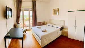 Un dormitorio con una cama y un televisor y una ventana. en Pang's Guesthouse, en Mestre