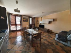 a kitchen and living room with a table and chairs at Casa La Ferula apt3 vicino al mare e Taormina con terrazza panoramica in SantʼAlessio Siculo