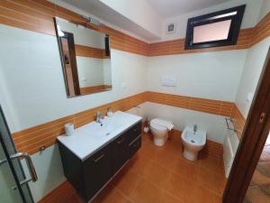 a bathroom with a sink and a toilet at Casa La Ferula apt3 vicino al mare e Taormina con terrazza panoramica in SantʼAlessio Siculo